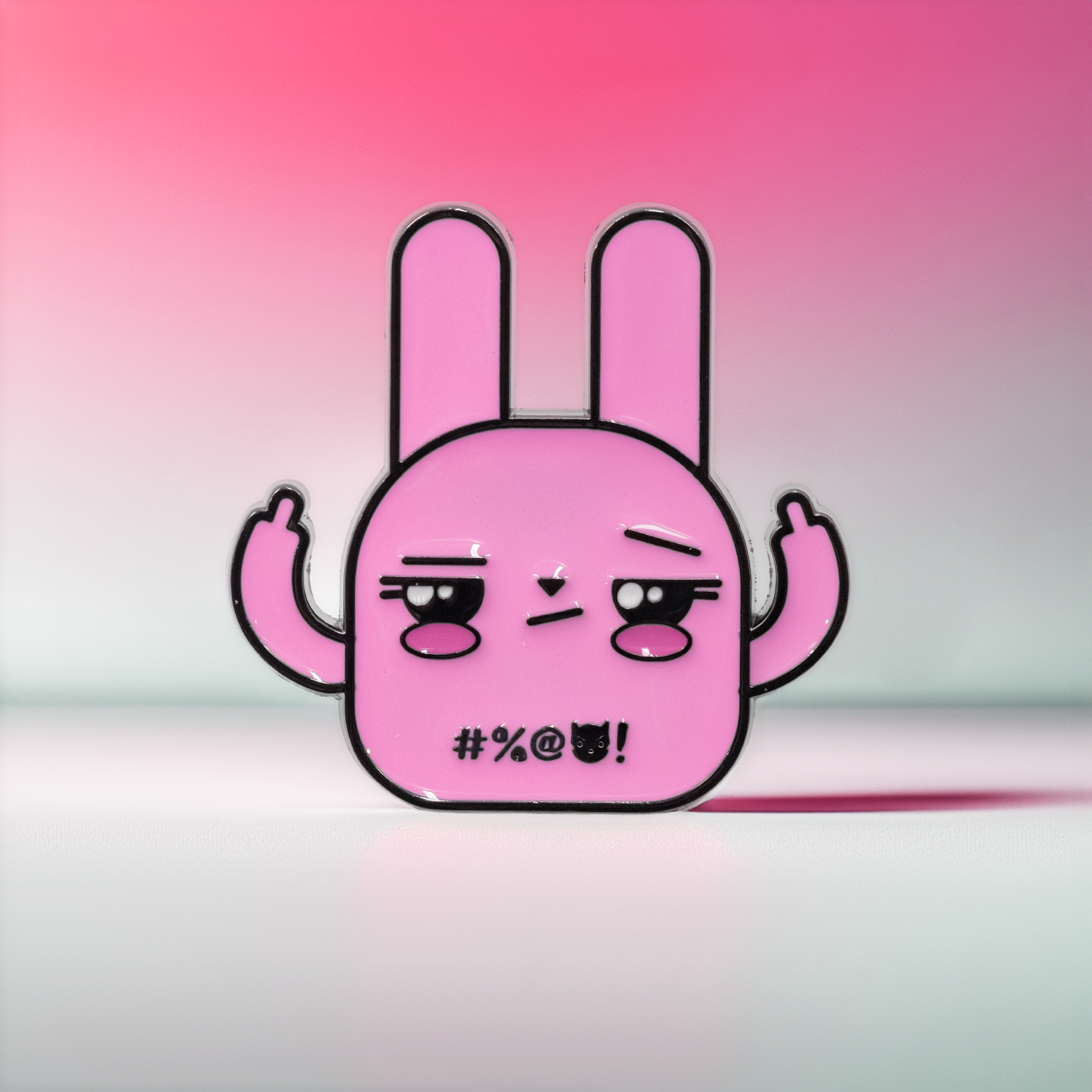 Pink bunny enamel pin with middle fingers up, front view