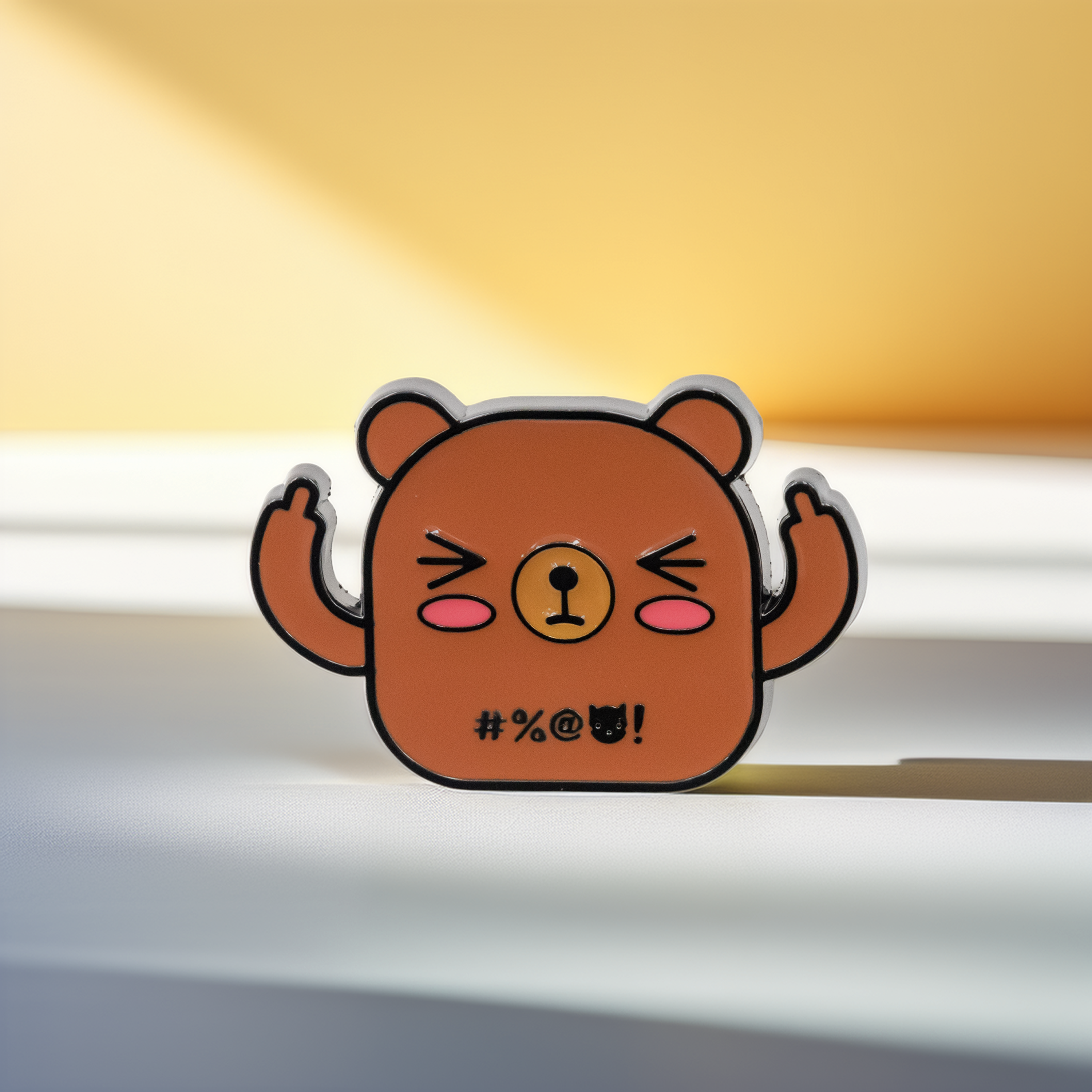 Brown bear enamel pin, middle fingers up, front view