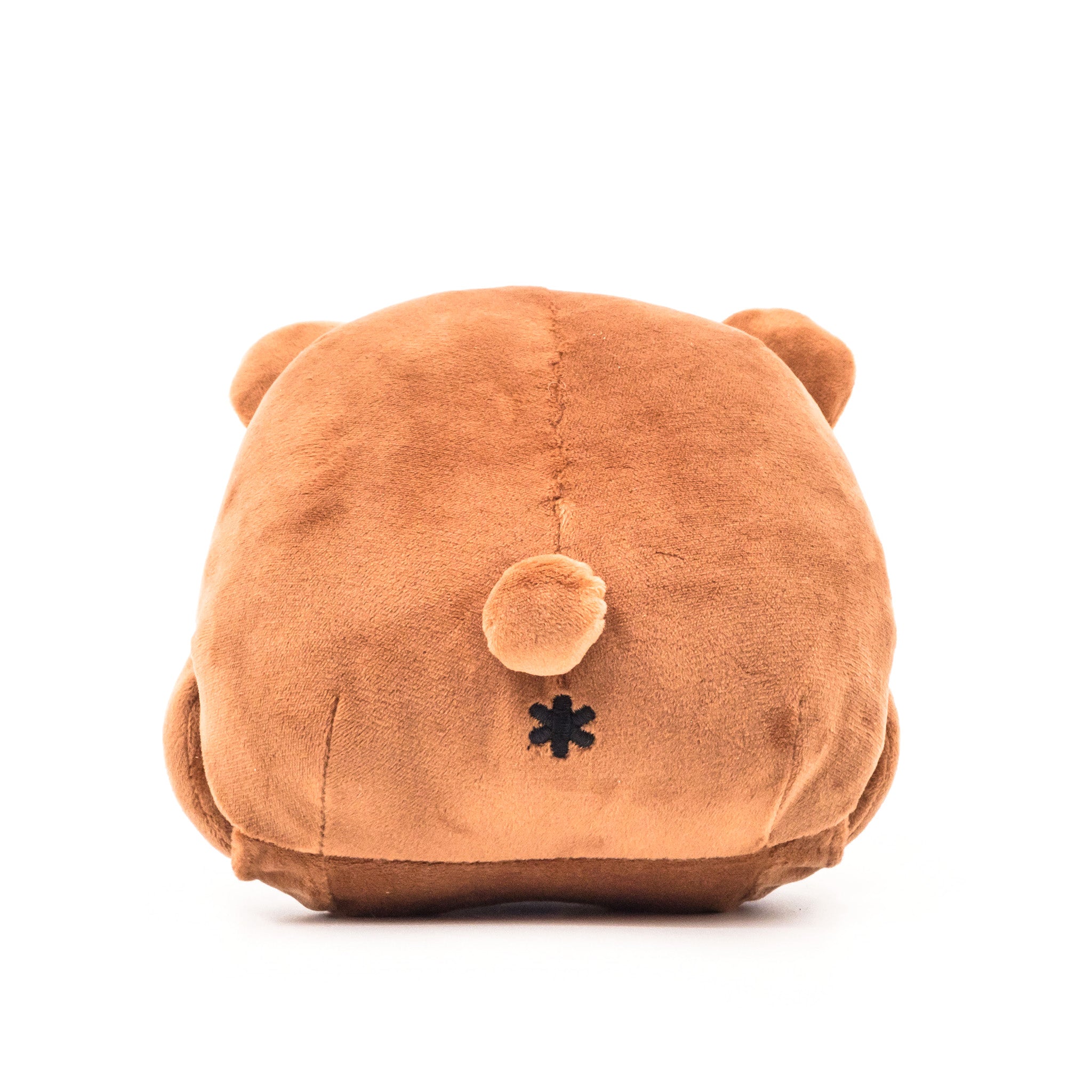 Brown bear plush, face down, showing tail and butthole, rear view.