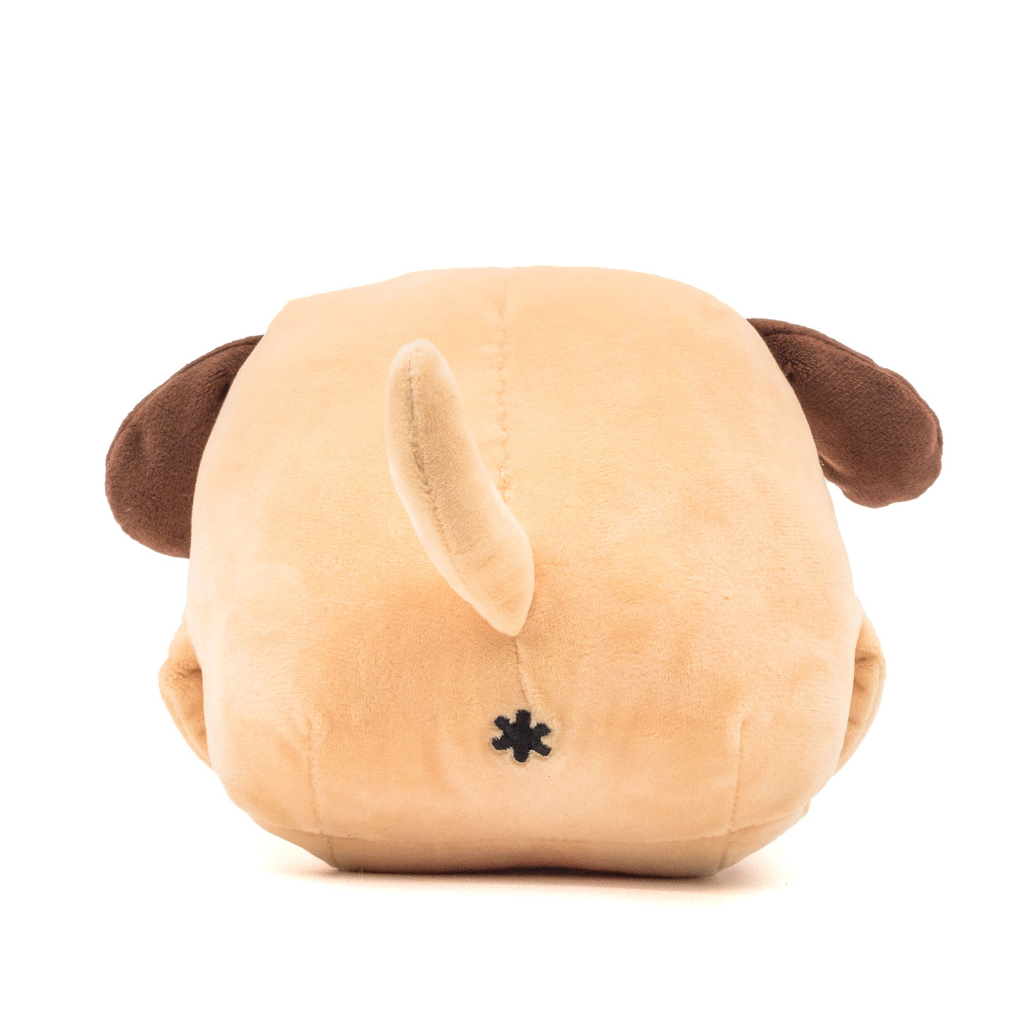 Beige dog plush, face down, showing tail and butthole, rear view.