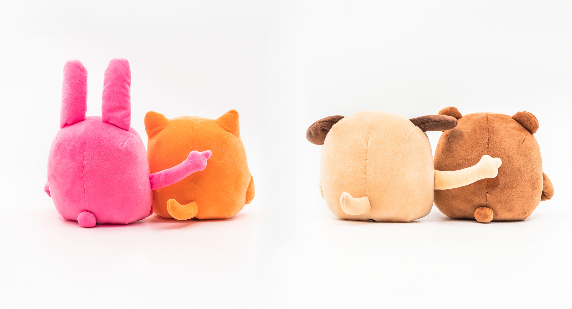 Pink bunny, orange cat, beige dog, brown bear, plush toys, rear view