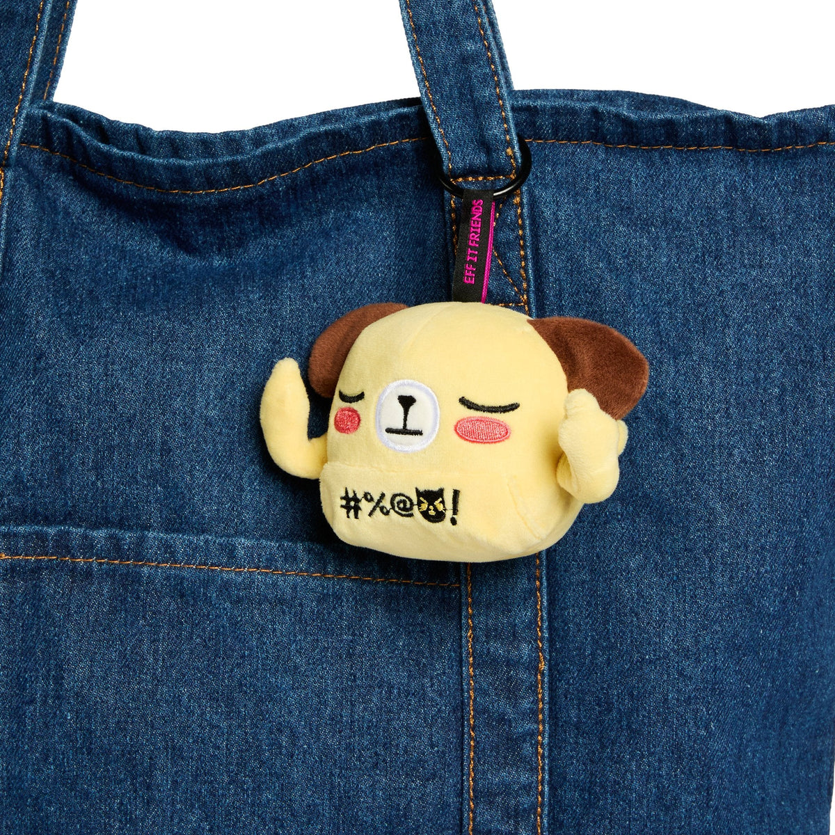 Kai keychain plush clipped to a denim tote
