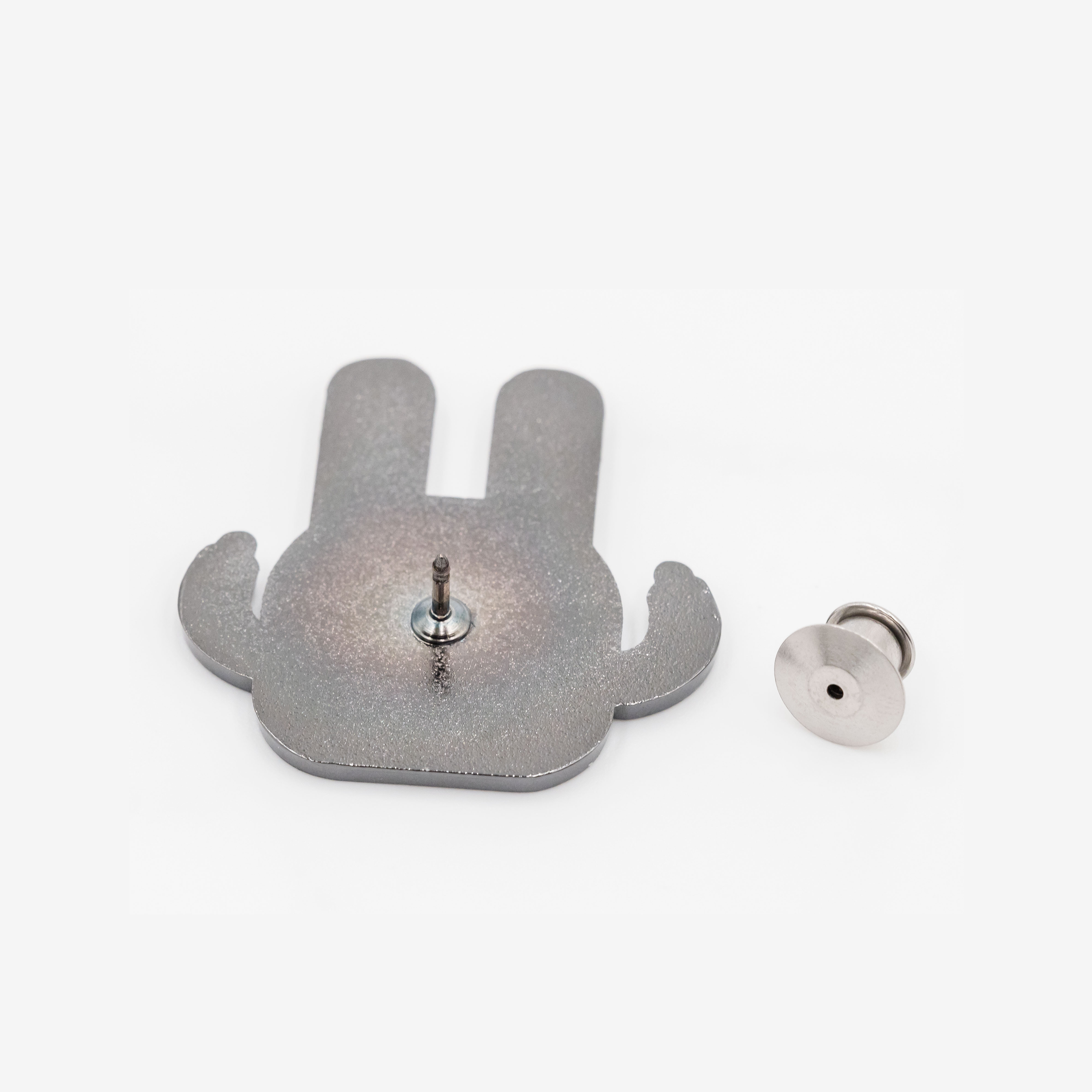 Bunny enamel pin and pin back, rear view, metallic silver on white background