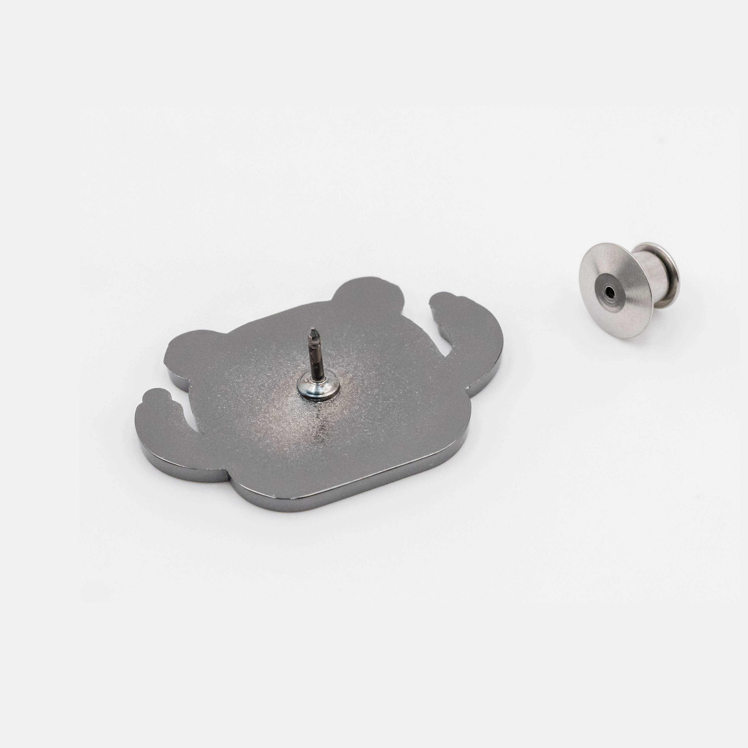 Bear enamel pin and pin back, rear view, metallic silver on white background