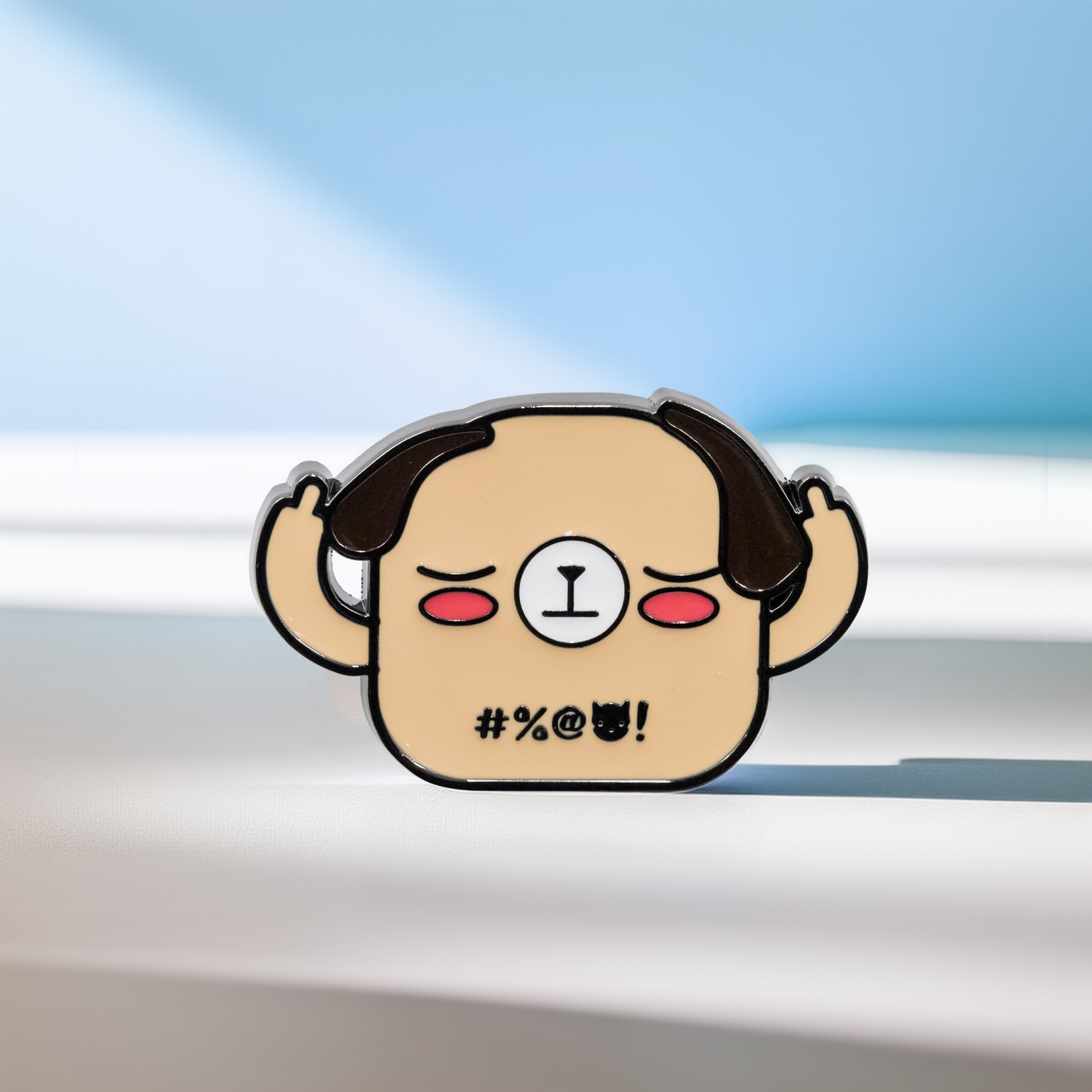 Beige dog enamel pin, middle fingers up, front view